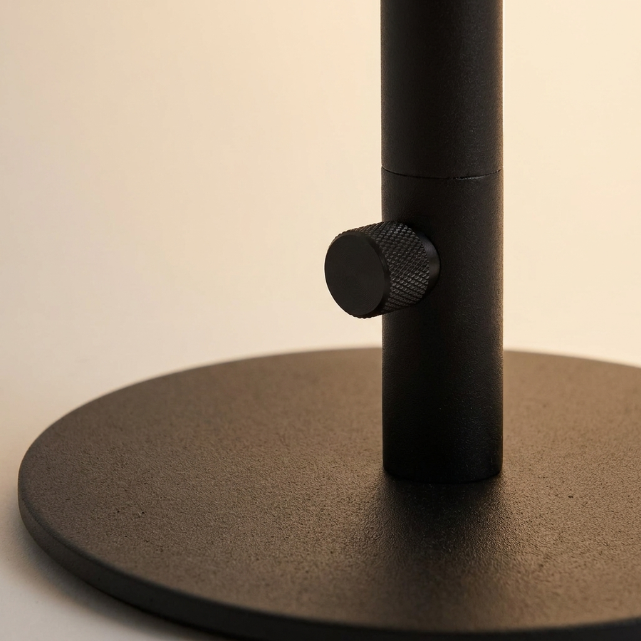 Close-up of the weighted round base and knob switch on the Minimalist Linear Floor Lamp
