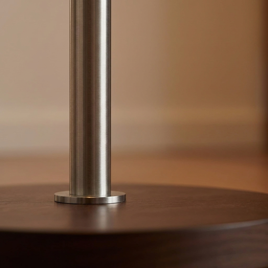 Close-up of the brushed metal stem and weighted base of the Bauhaus Mushroom Floor Lamp