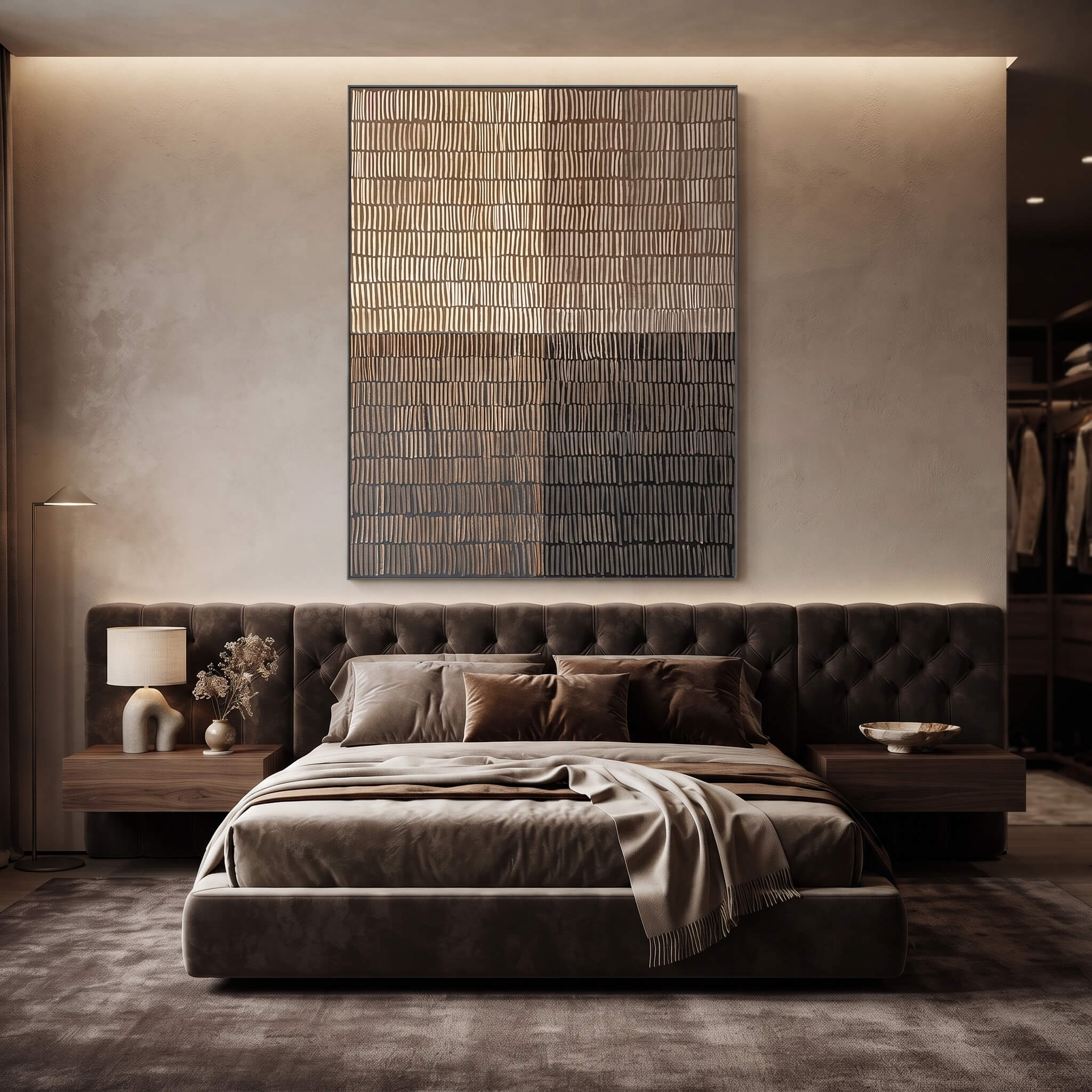A modern bedroom featuring a low tufted platform bed in dark brown velvet, styled with matching brown bedding and pillows. The bed is centered beneath a large vertical abstract canvas art piece on a textured beige wall, flanked by matching wood nightstands with a lamp and decorative vase.