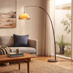 Mid Century Arc Floor Lamp with its amber dome glowing in a styled interior