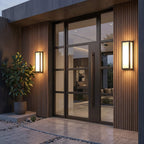 Sentry wall light lighting a modern entryway after dark