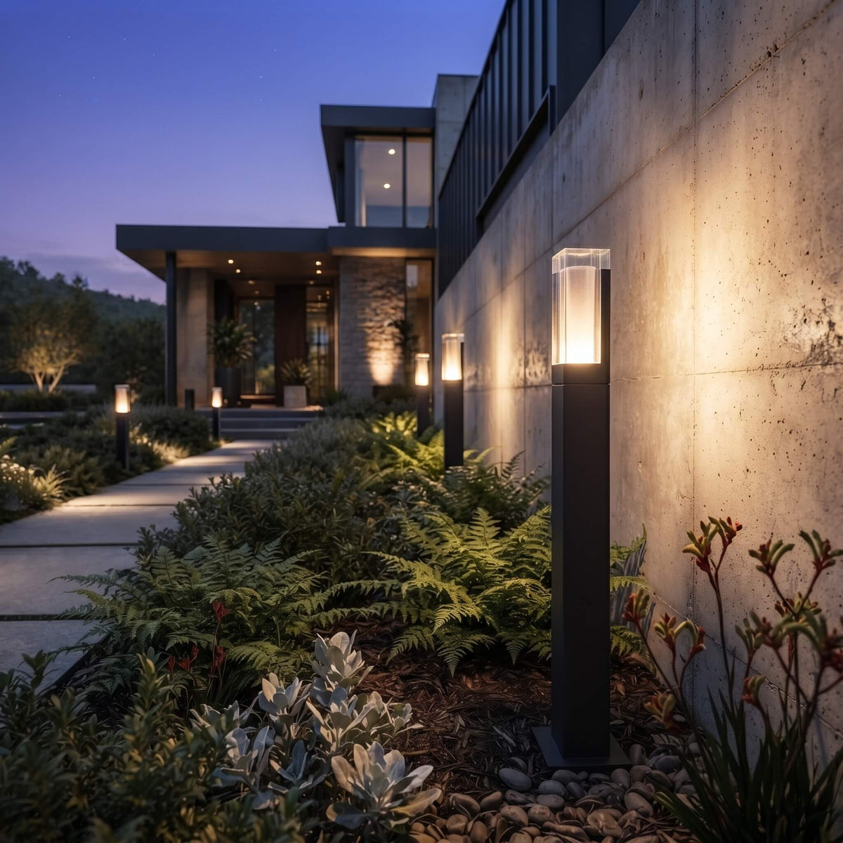 Beacon bollard lights illuminating a landscaped garden after dark