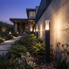 Beacon bollard lights illuminating a landscaped garden after dark
