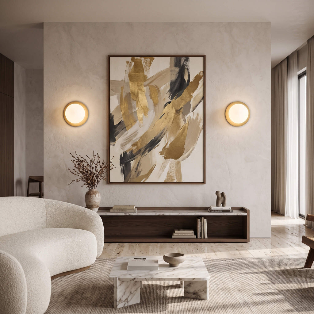 Brass globe wall sconces flanking artwork in a living room