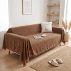 Brown textured sofa cover throw on a couch in a light living room