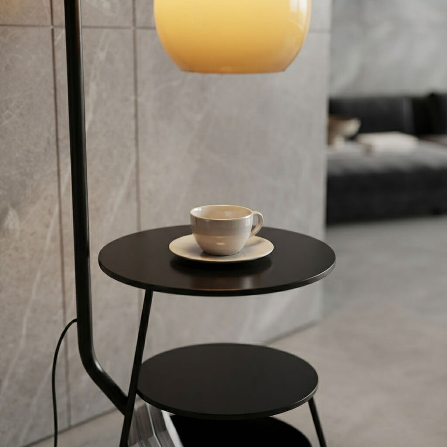 Close-up of the two tier black side table with drum book storage built into the French Mid Century Arc Floor Lamp
