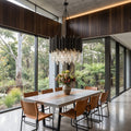 Obsidian crystal chandelier above a dining table in a modern home