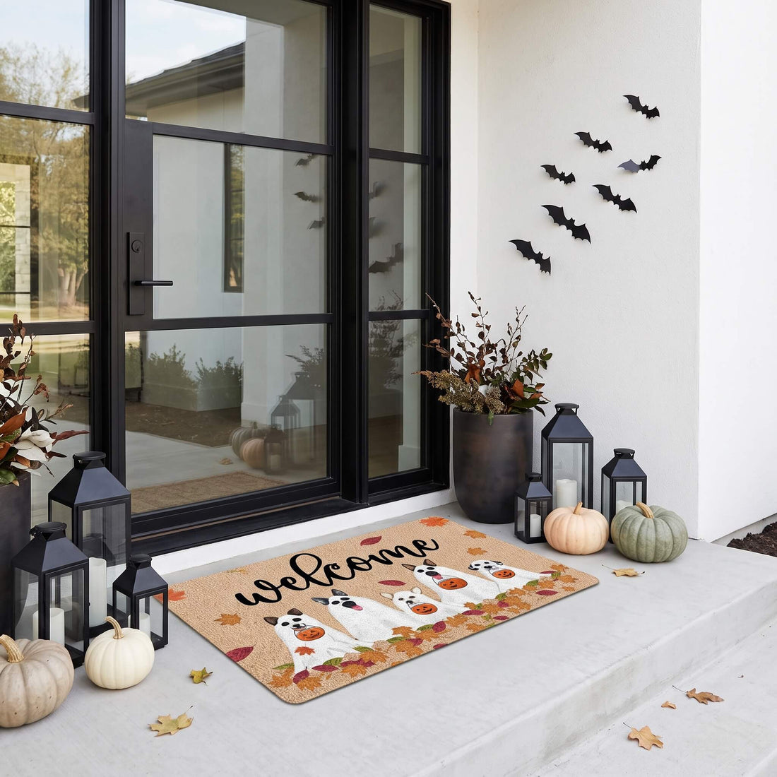 Welcome Ghosts Halloween doormat at a modern glass front door