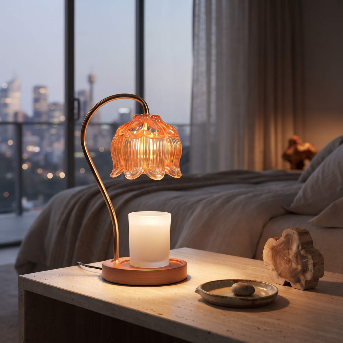 Amber glass candle warmer lamp glowing warm in the evening
