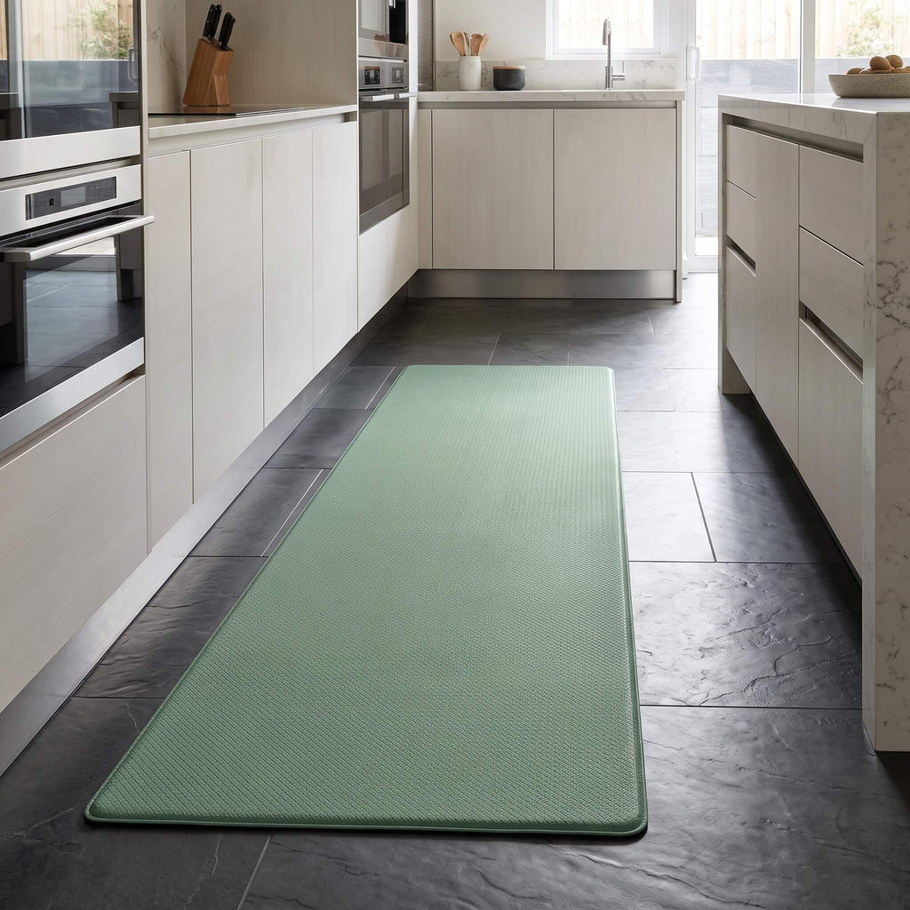 Mint green anti fatigue kitchen mat on a kitchen floor