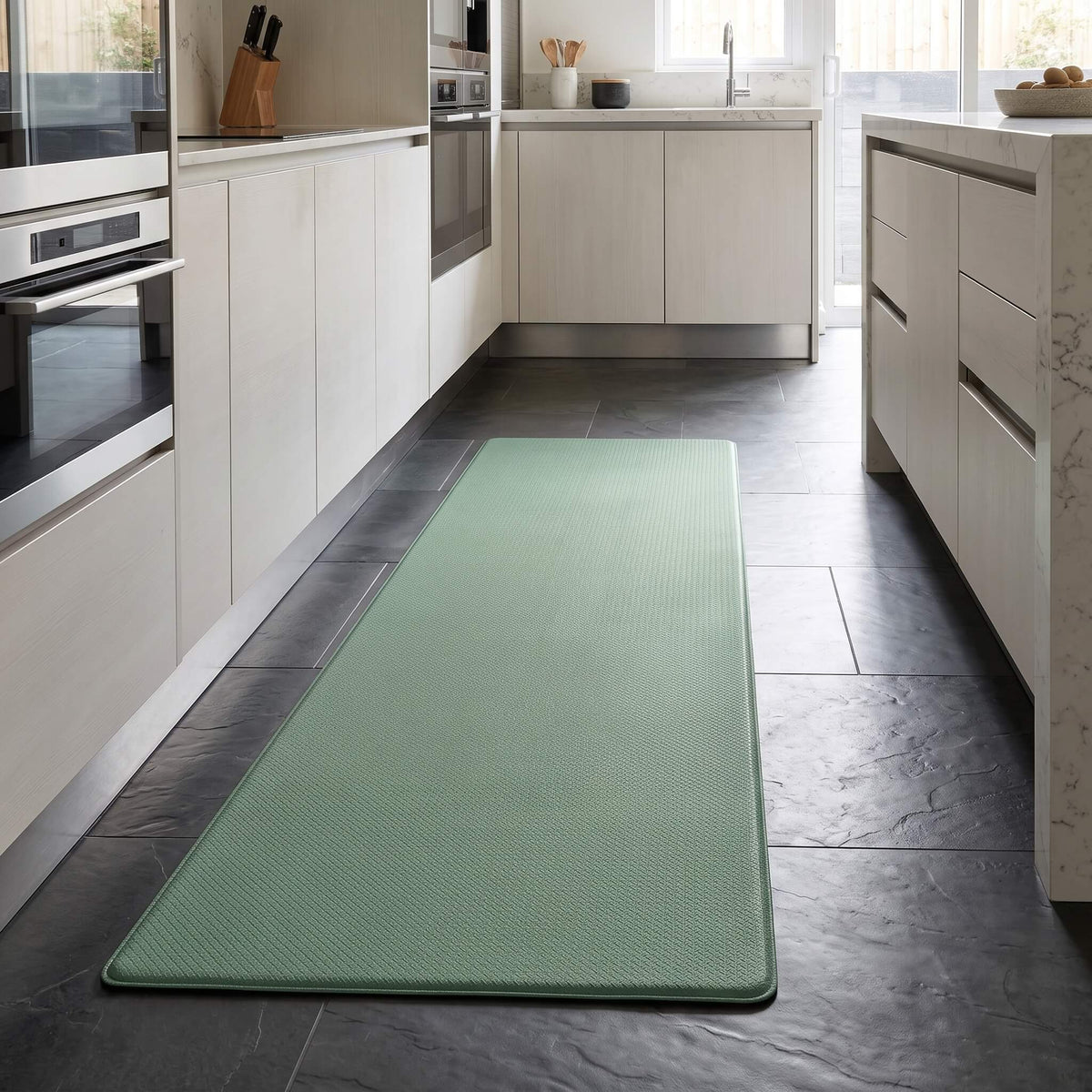 Mint green anti fatigue kitchen mat on a kitchen floor