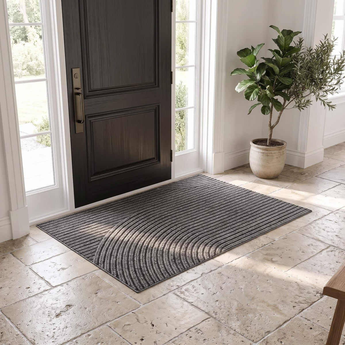 Grey ribbed non slip door mat at a front entrance on travertine tile