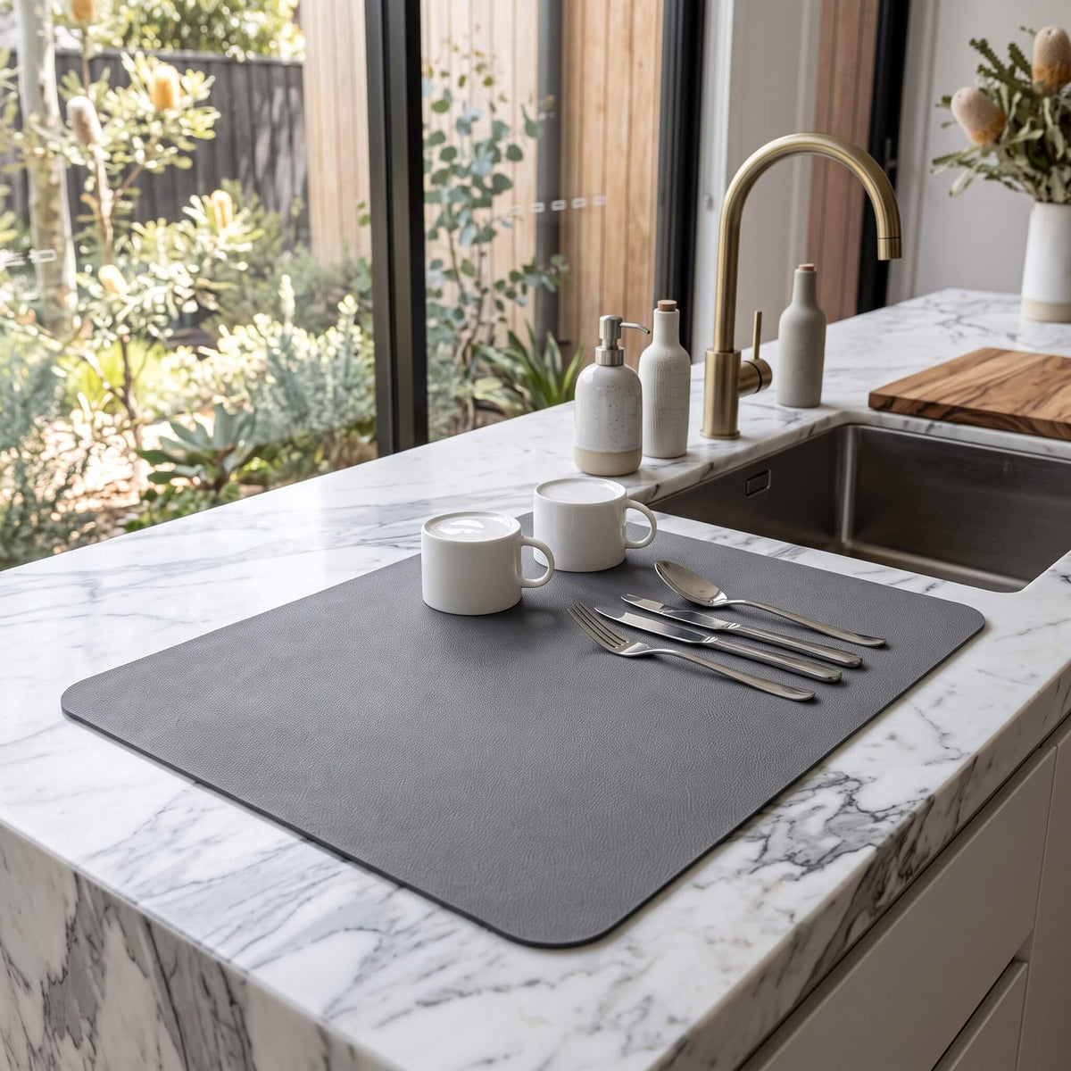 Grey quick dry dish drying mat beside a kitchen sink