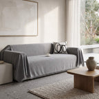 Grey textured sofa cover throw on a couch in a neutral living room