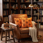 Jack-o'-Lantern cushions on a leather armchair in a library