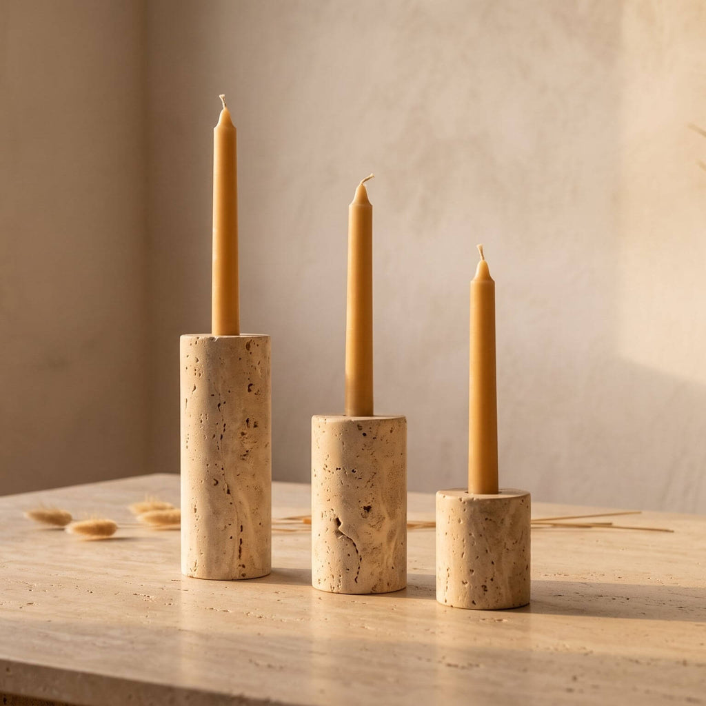 Three cork candle holders with beeswax candles on a wooden surface.
