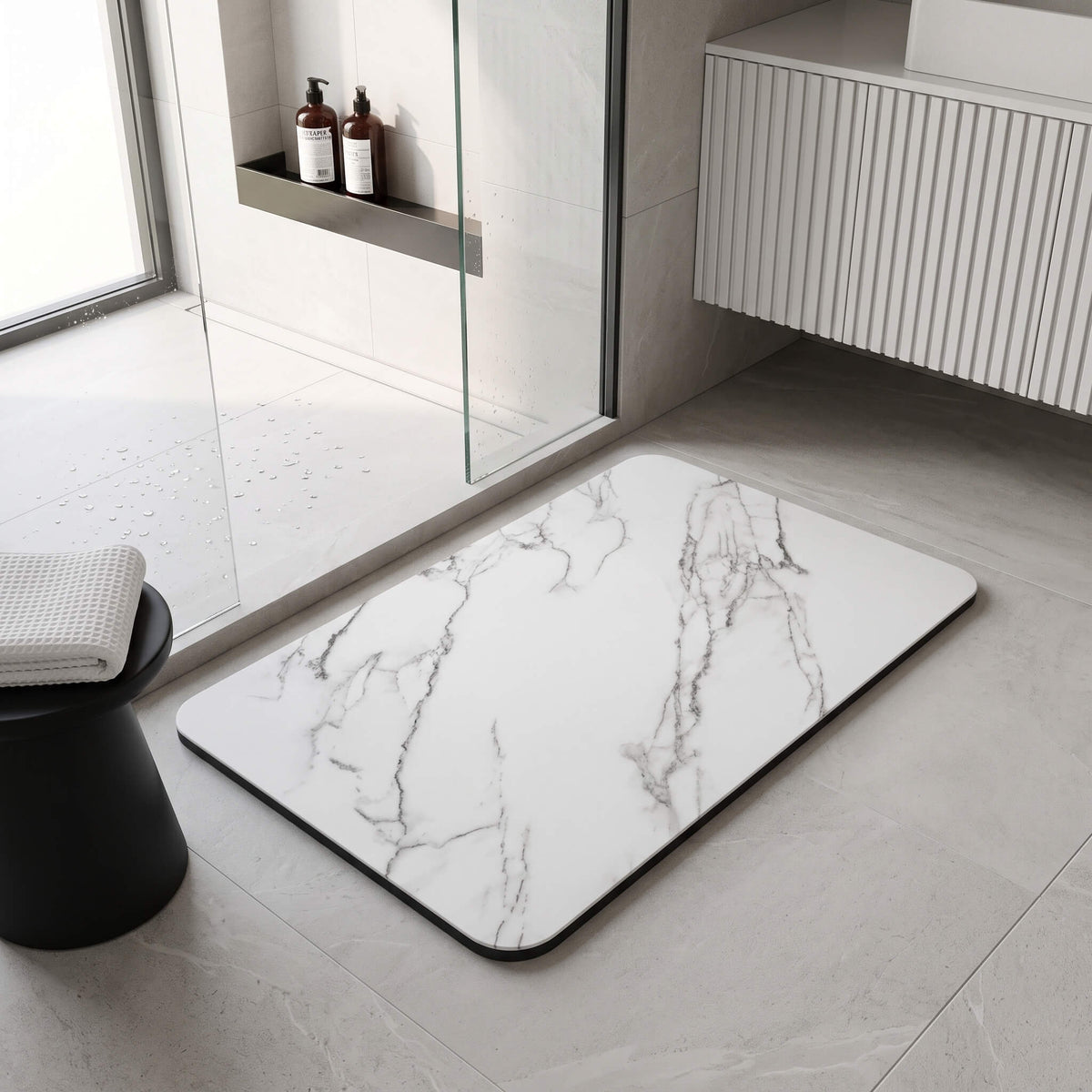 Marble look bath mat laid flat beside a vanity