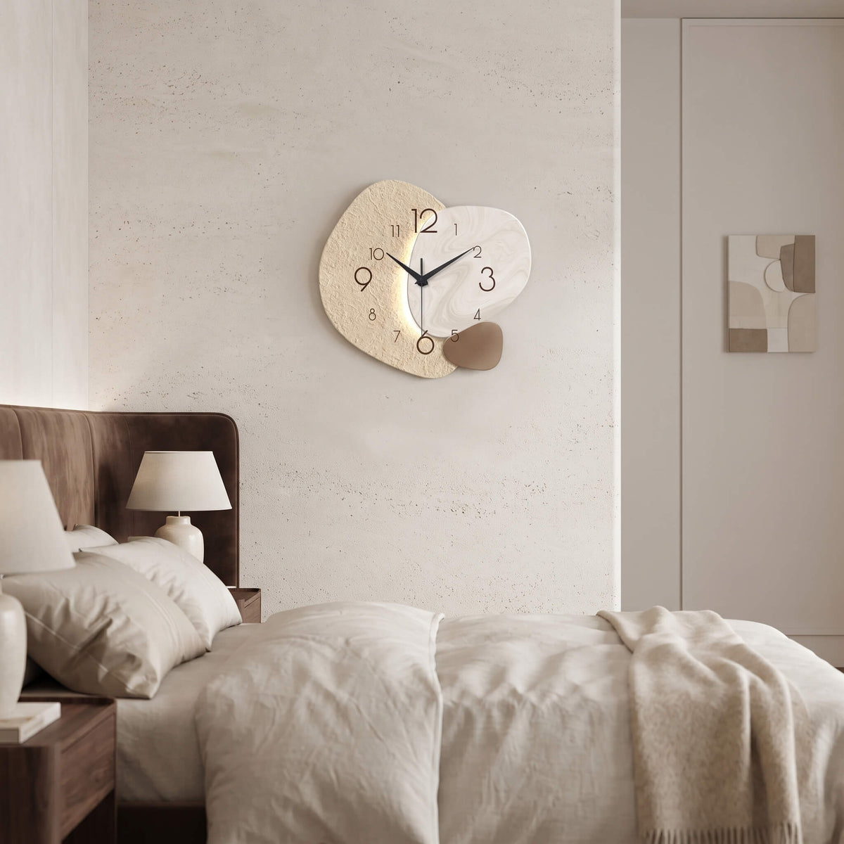 Stone textured abstract wall clock above a bed in a neutral bedroom