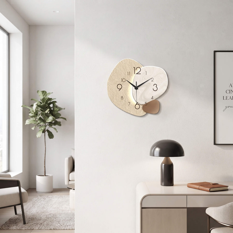 Modern abstract wall clock on a white wall above a sideboard