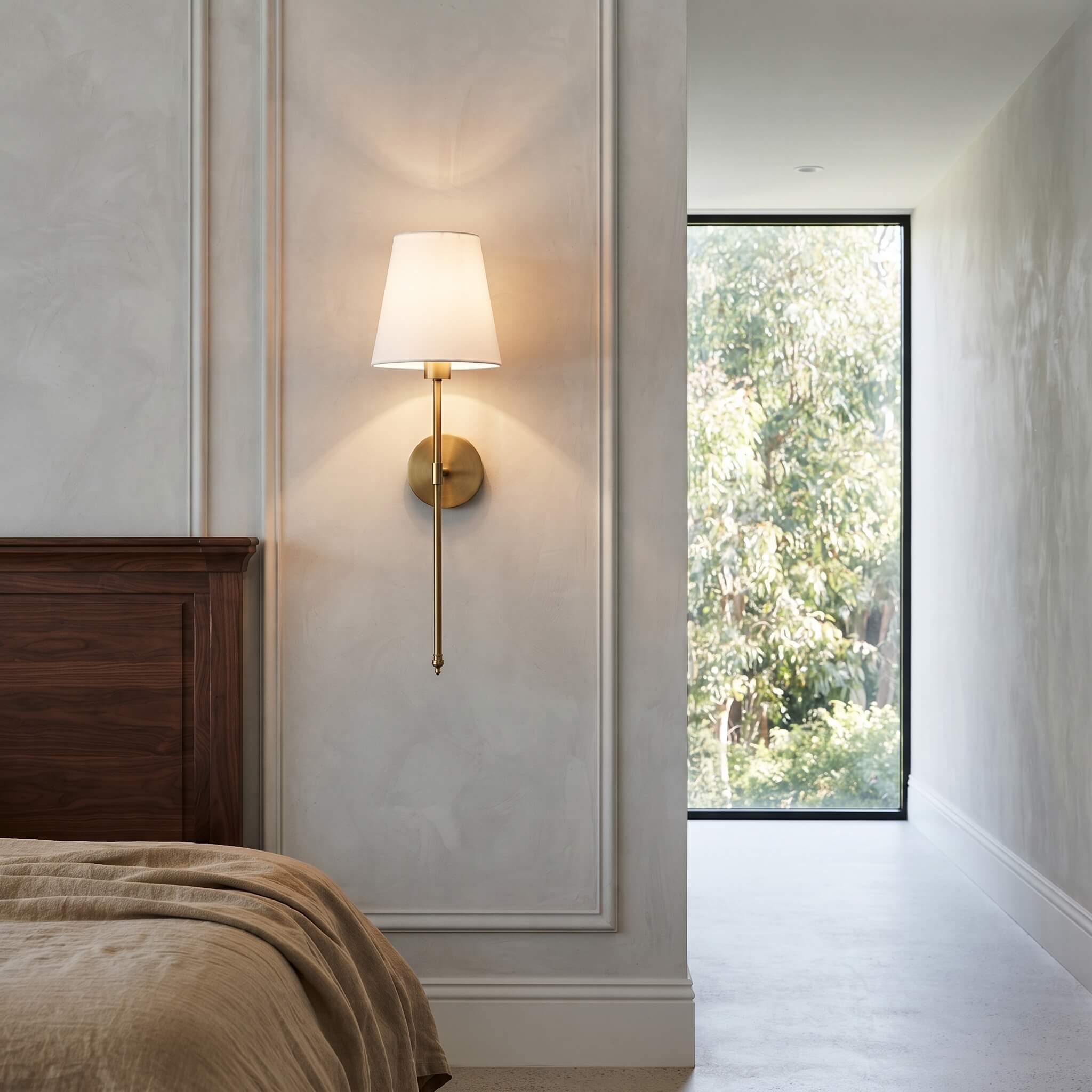 Brass finish stem and tapered shade on a panelled bedroom wall