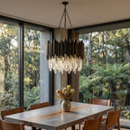 Obsidian crystal chandelier silhouetted against a large window
