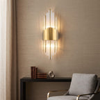 Brushed brass and clear glass rods against a grasscloth wall