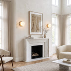 Globe wall lamps flanking a fireplace mantel