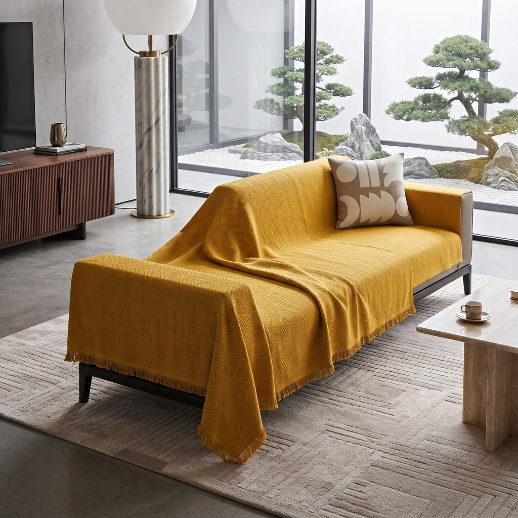 Mustard textured woven sofa cover throw draped over a couch in a warm living room