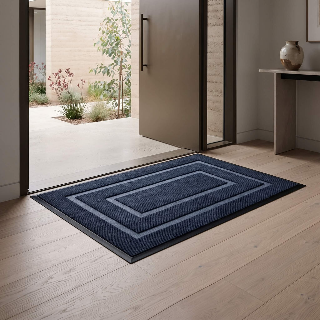 Navy blue non slip door mat lying flat on the floor