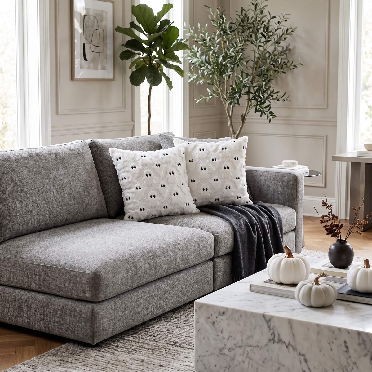 Ghost cushion covers arranged on a grey sofa