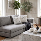 Ghost cushion covers arranged on a grey sofa