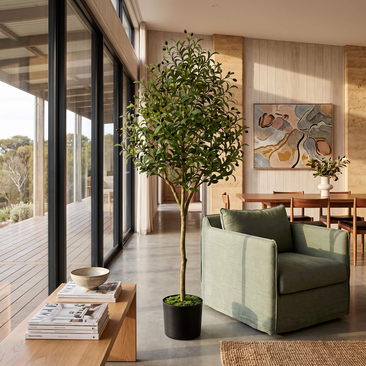 Placing the large faux olive tree in a corner of a room