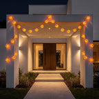 Pumpkin lantern string lights strung across a modern entry portico