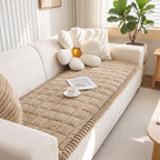 Quilted beige sofa cover showing the stitched panels