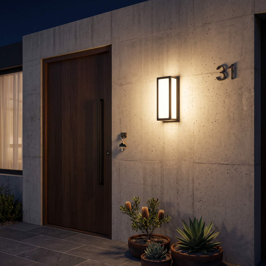 The Sentry wall light casting an even wash of warm light across an exterior wall
