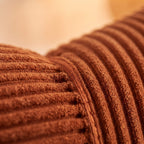 Close-up of a ribbed brown textile surface with a soft, warm-toned blurred background.