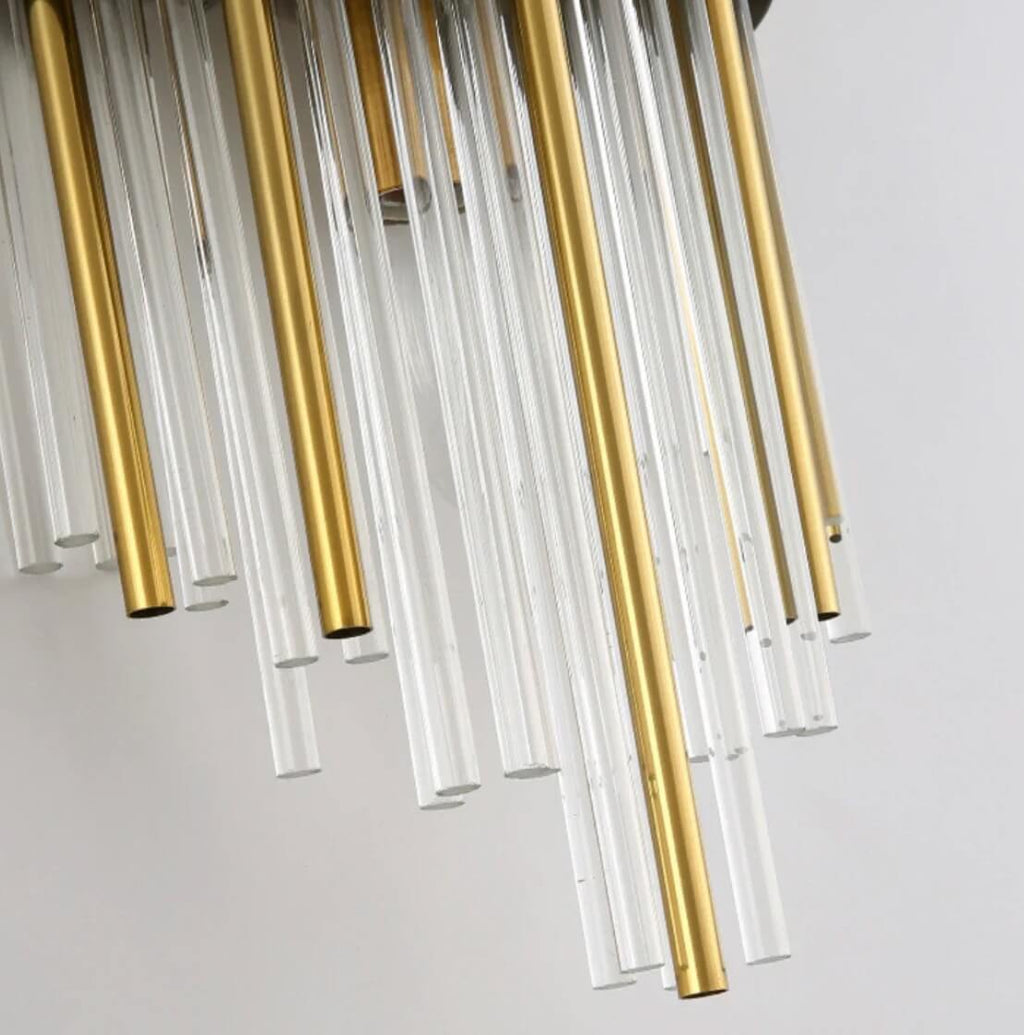 Close view of the clear glass and brass rods on the art deco sconce