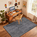 Grey non slip flat pile area rug under a desk and chair
