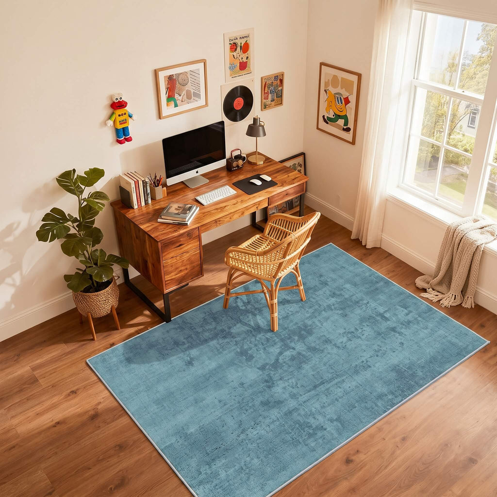 Blue non slip flat pile area rug in a study
