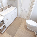 Faux sisal mat on a bathroom floor beside a basin