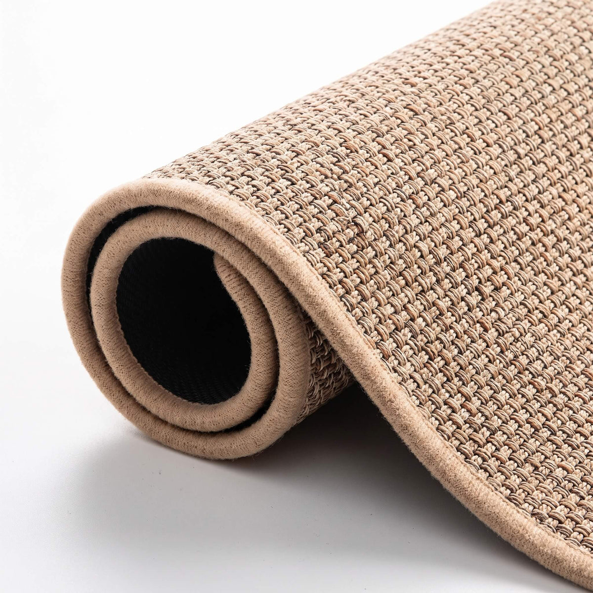 Rolled faux sisal mat showing the flat woven texture and backing