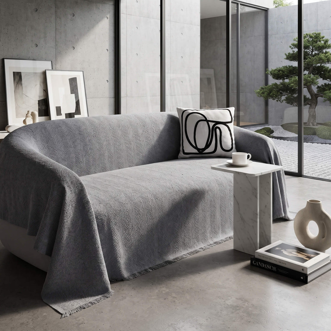 Grey sofa cover throw showing the fringed edge draping over the arm