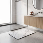 Quick dry bath mat lying flat on a tiled floor
