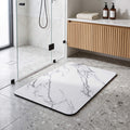 Quick dry stone look bath mat on a bathroom floor