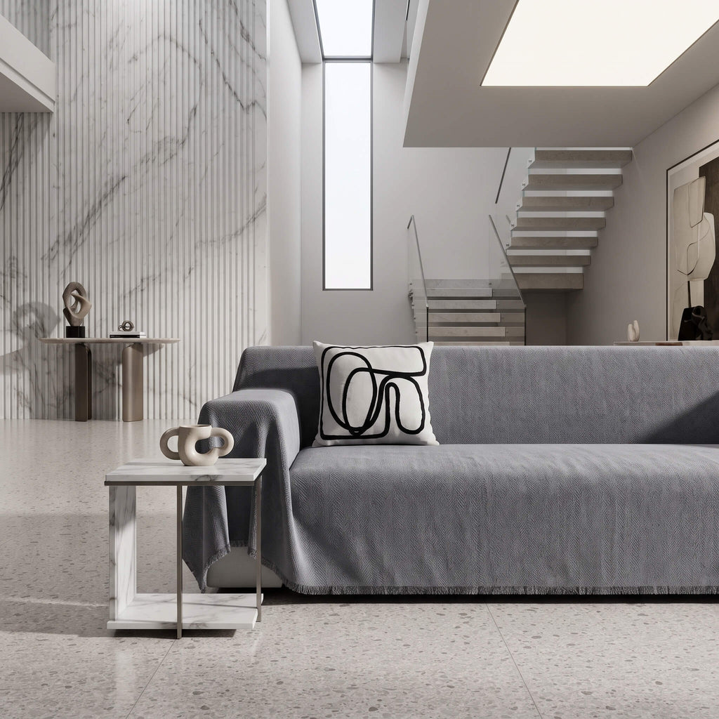 Grey sofa cover throw in a double height foyer