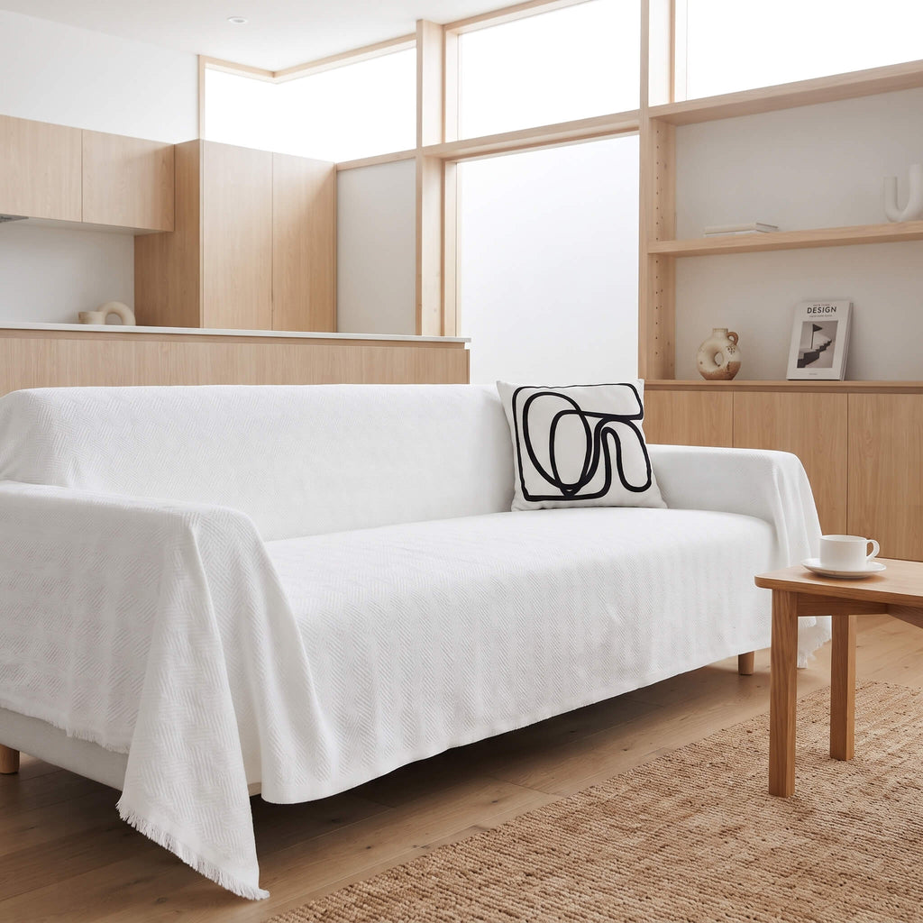 White textured sofa cover throw on a couch in a bright open plan room