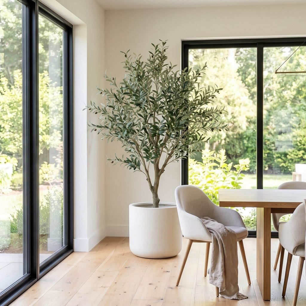 Modern dining room with a large indoor plant and large windows.