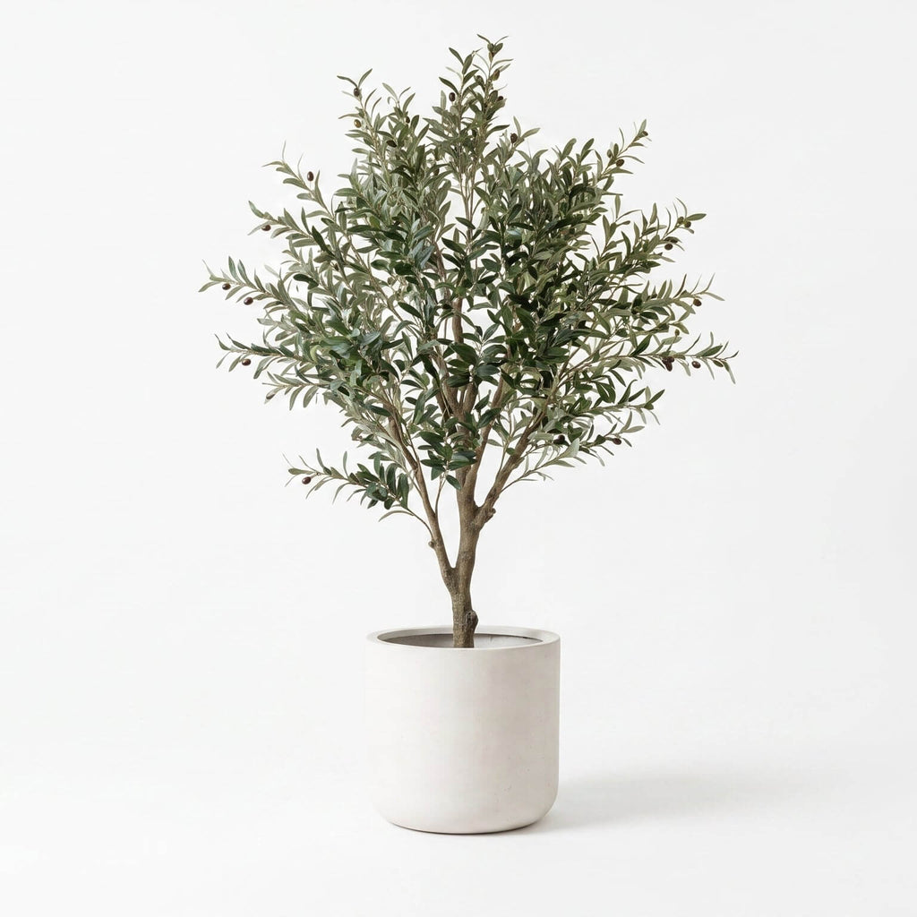 An artificial olive tree with dense, silvery-green leaves and brown branches, potted in a minimalist white cylindrical planter against a clean white background.