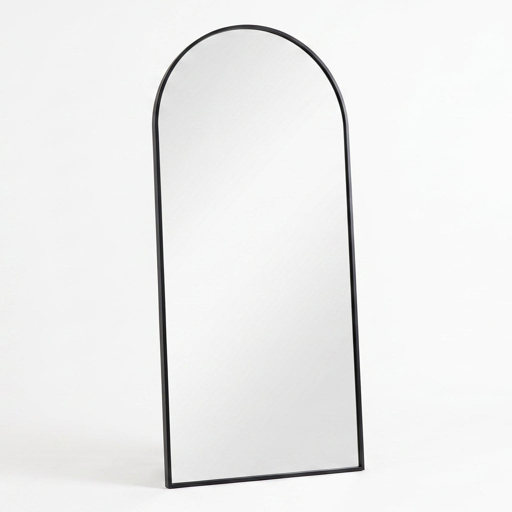 Arched mirror with black frame on a white background