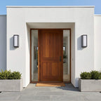 Sentry wall lights flanking a stucco doorway on a modern home facade